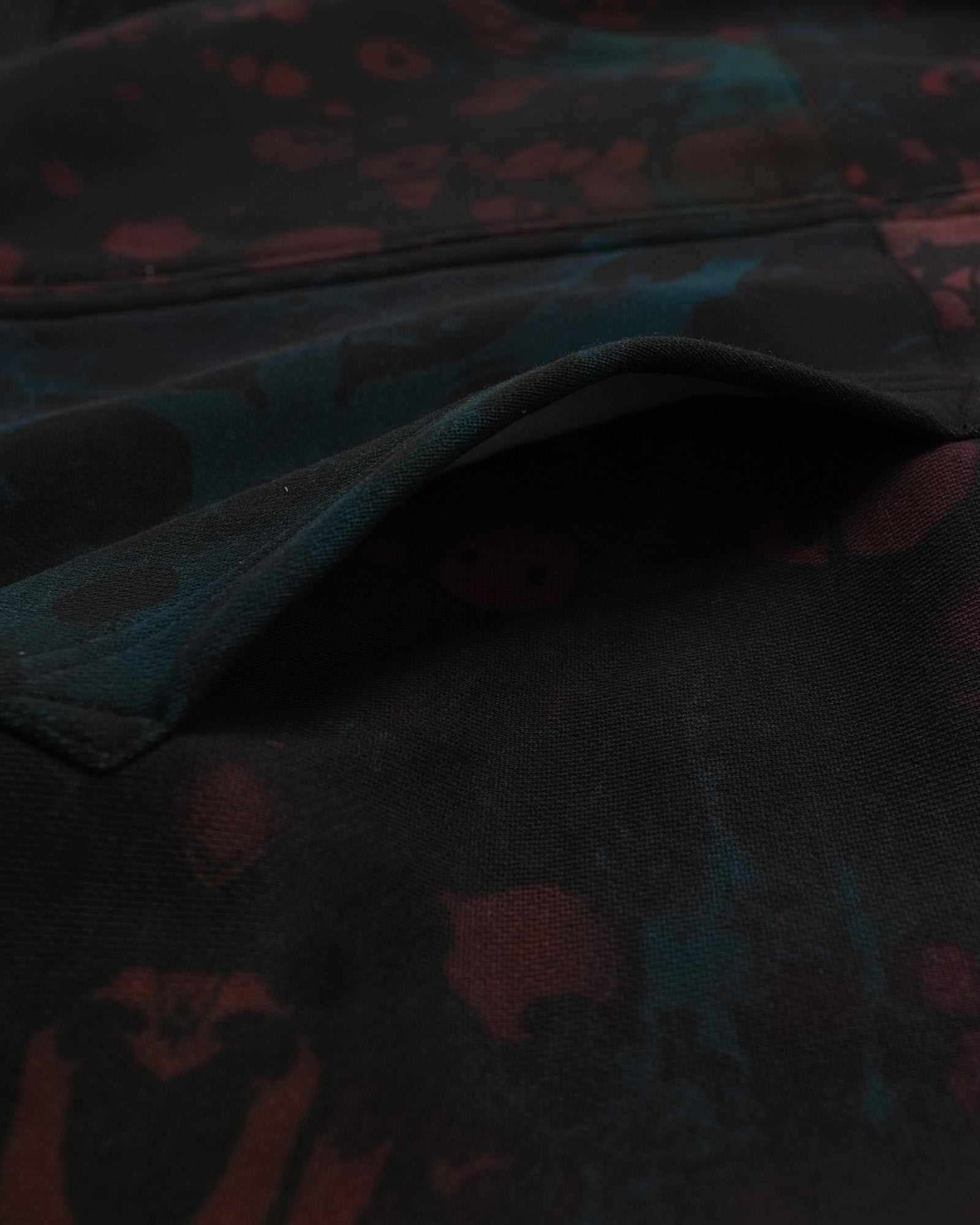 Dark fabric with red and blue abstract patterns