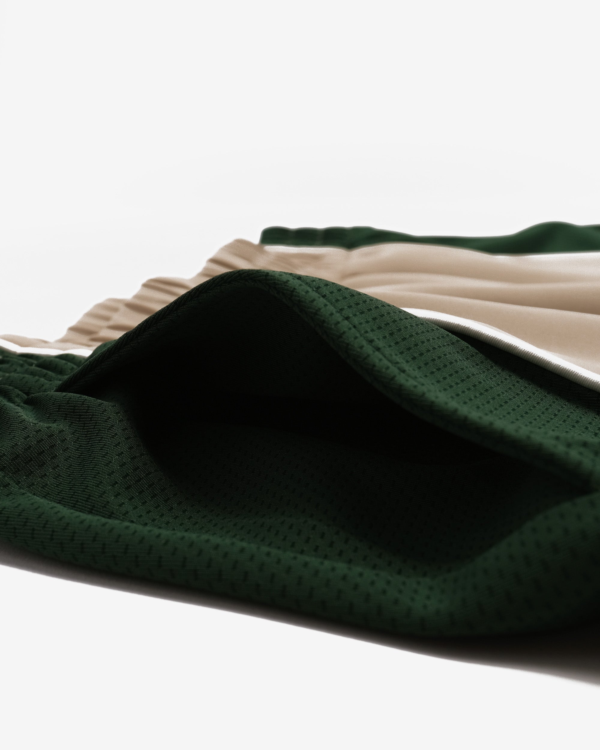 Close-up of green fabric with a textured pattern on a white background