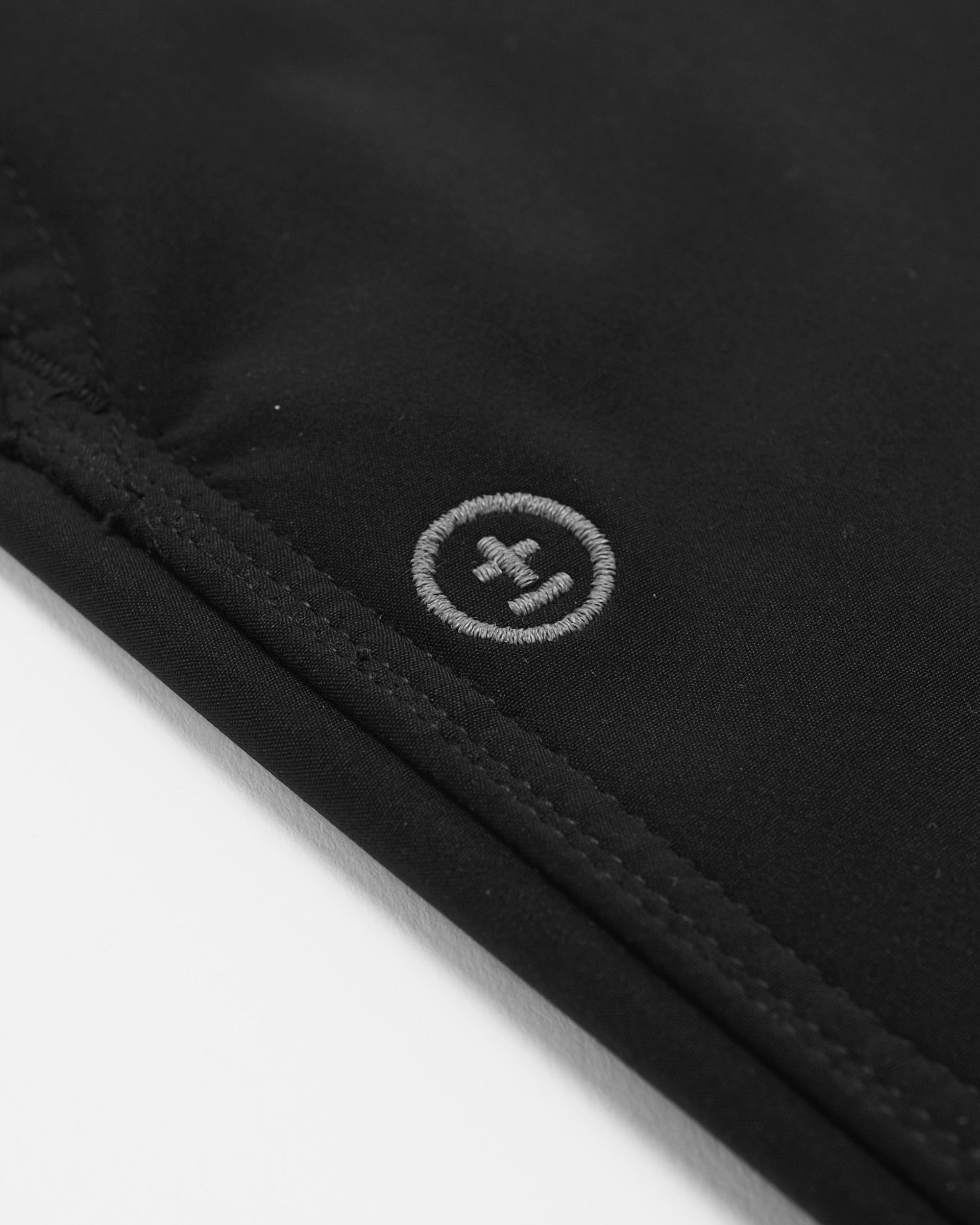 Close-up of a black fabric with a logo on a white background
