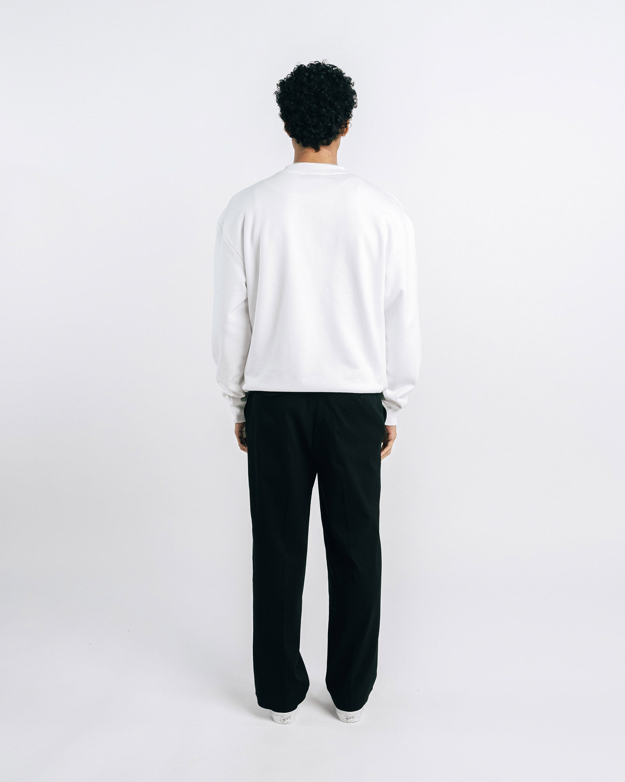 Person wearing a white sweatshirt with 'Honor Roll' text on a plain background