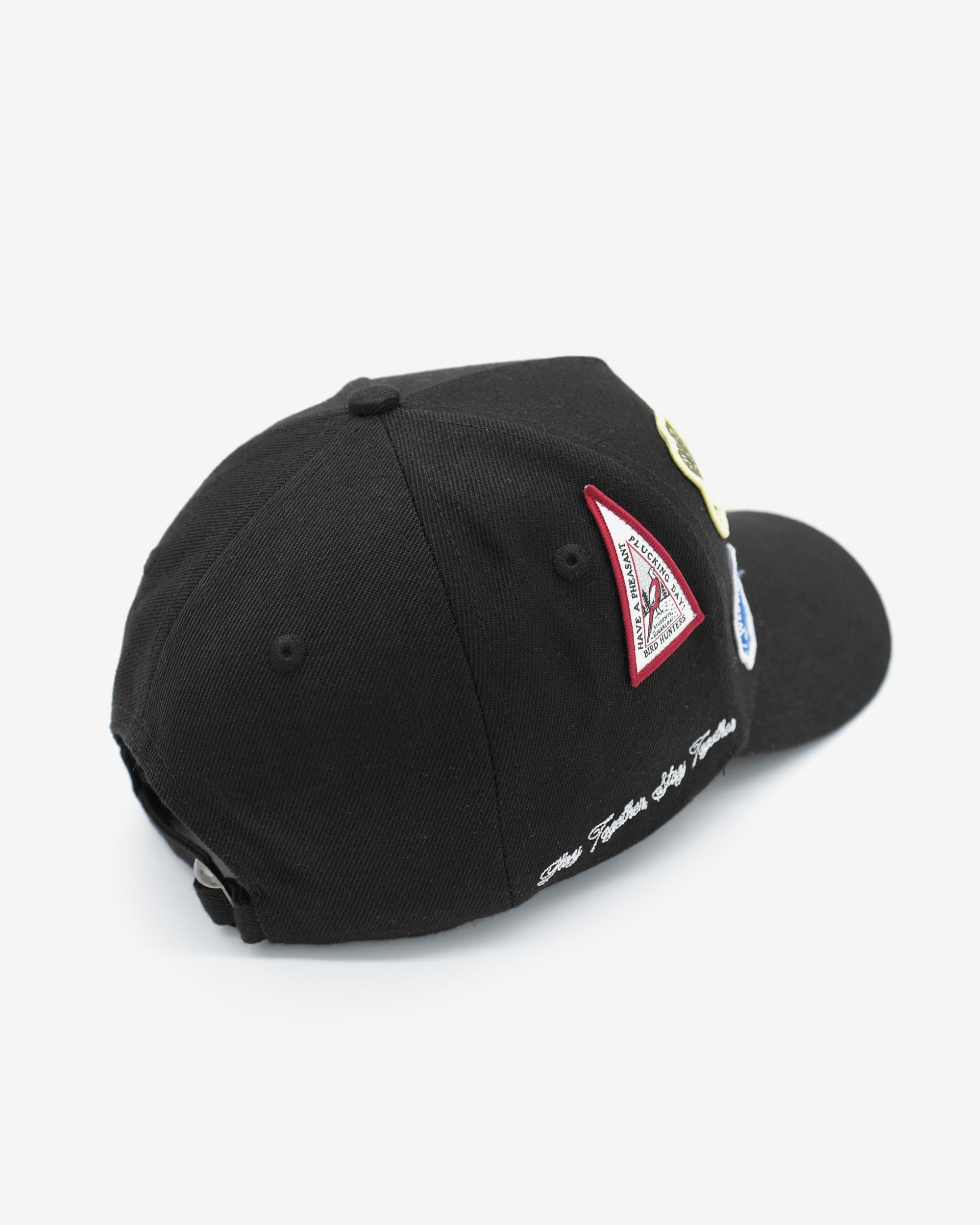 Black cap with a red and white logo on a light gray background