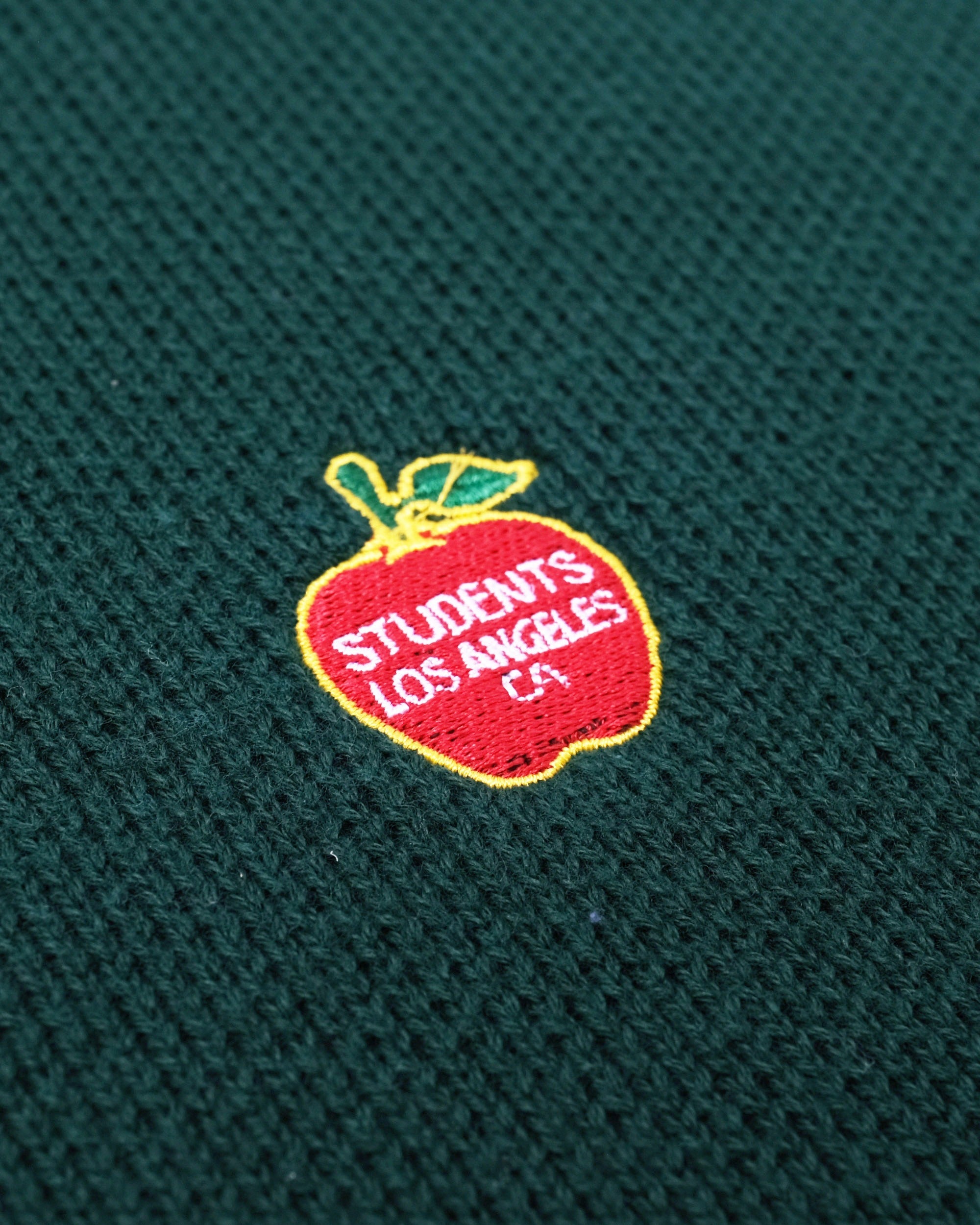 Embroidered apple logo with 'Students Los Angeles CA' text on a green background