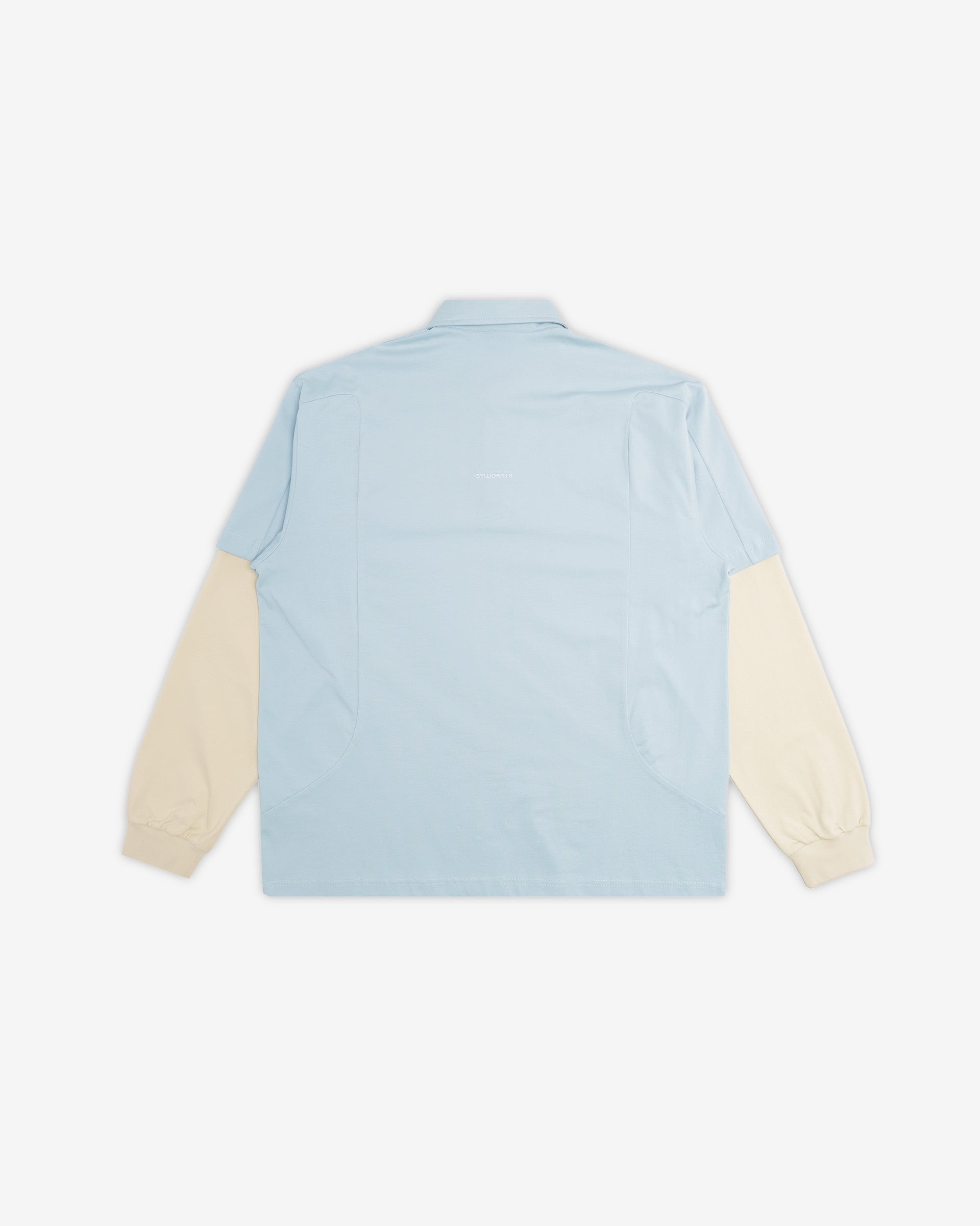 Light blue shirt with cream sleeves on a white background
