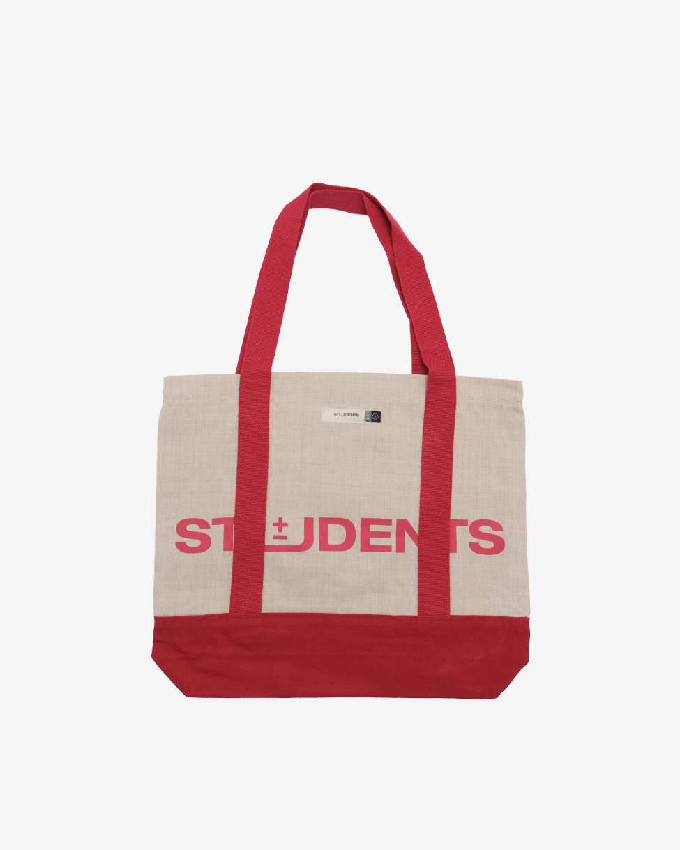 Tote bag with red handles and 'STUDENTS' text on a beige background