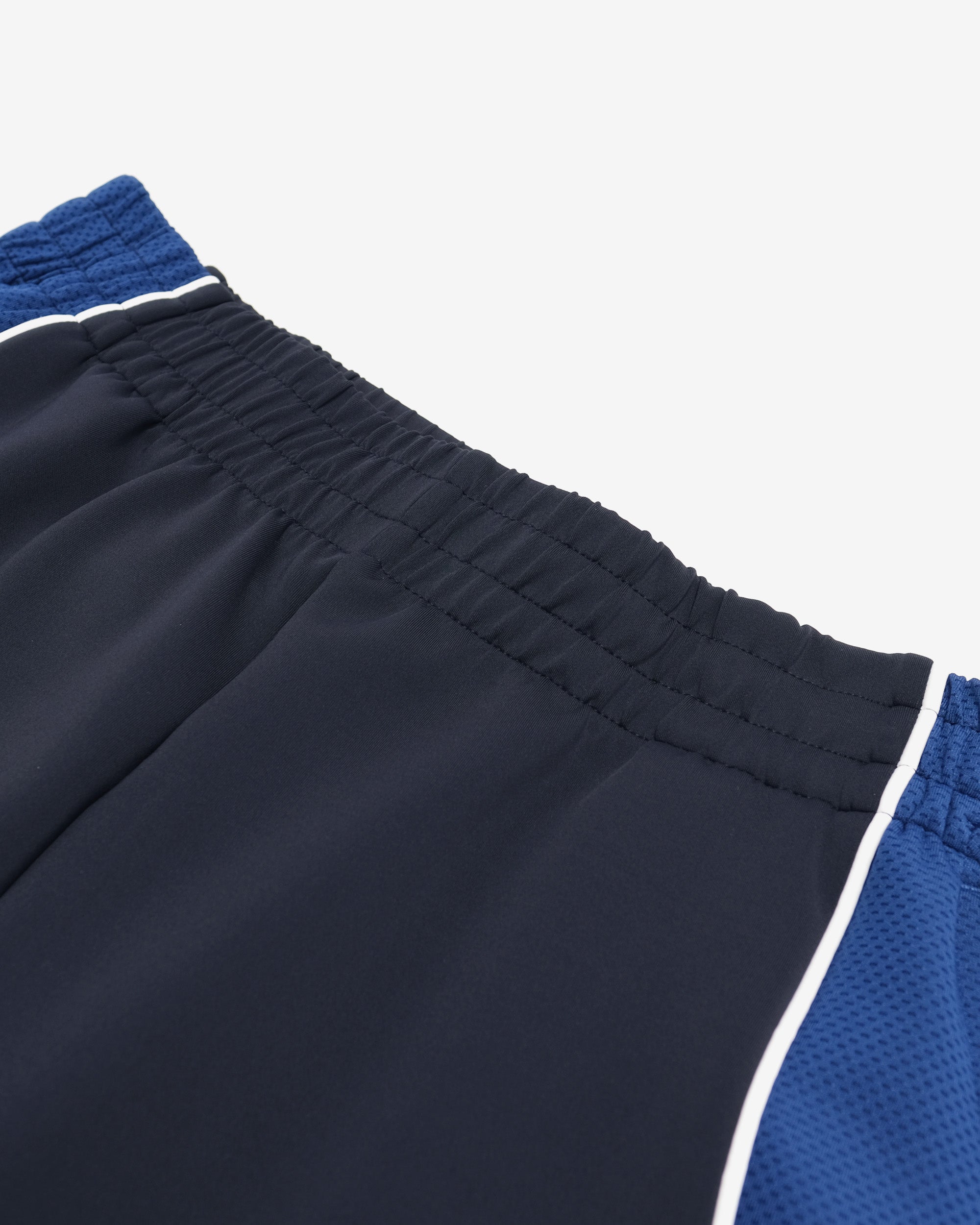 Close-up of navy shorts with blue and white trim on a light gray background