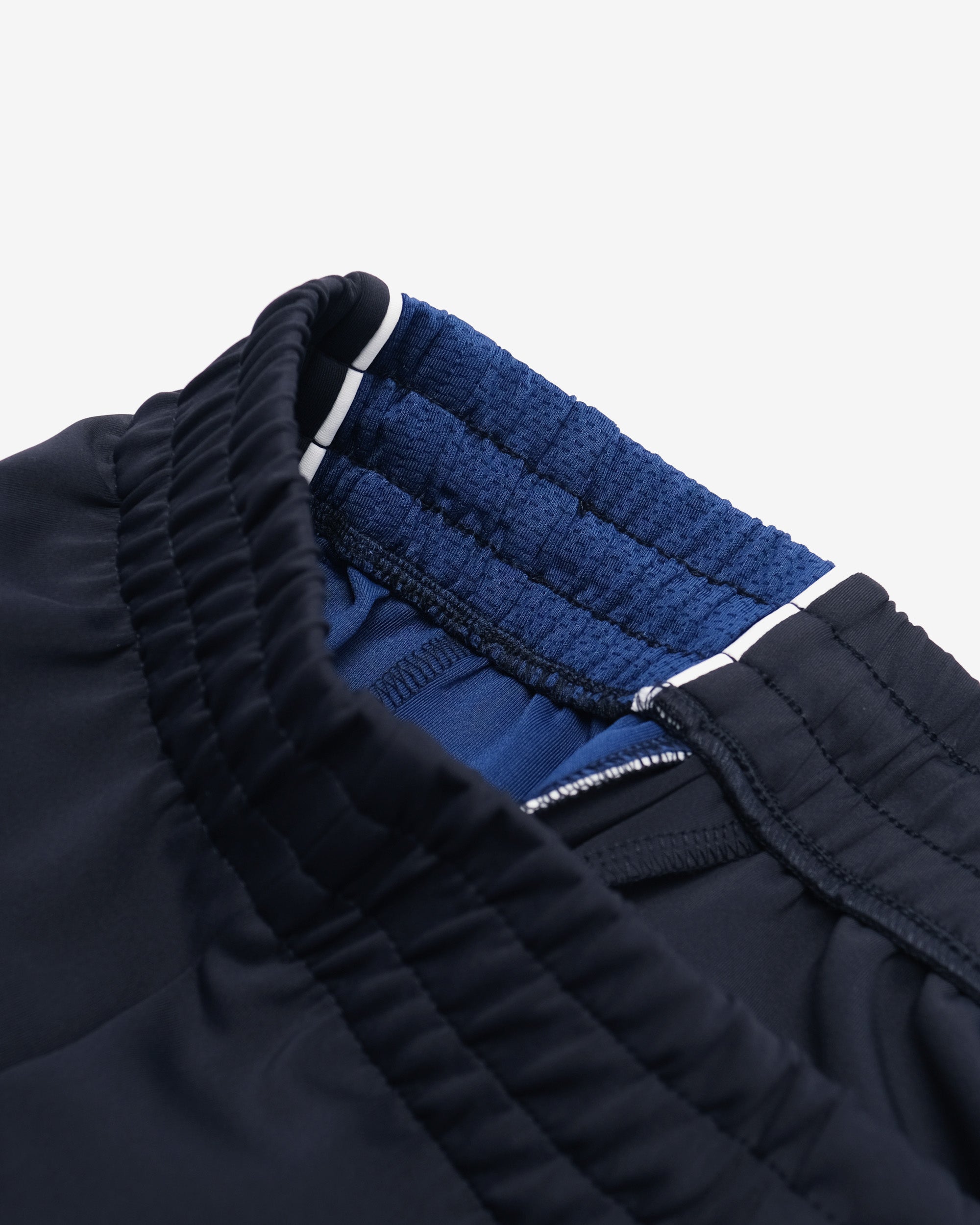 Close-up of a navy blue jacket with a textured pattern on a white background