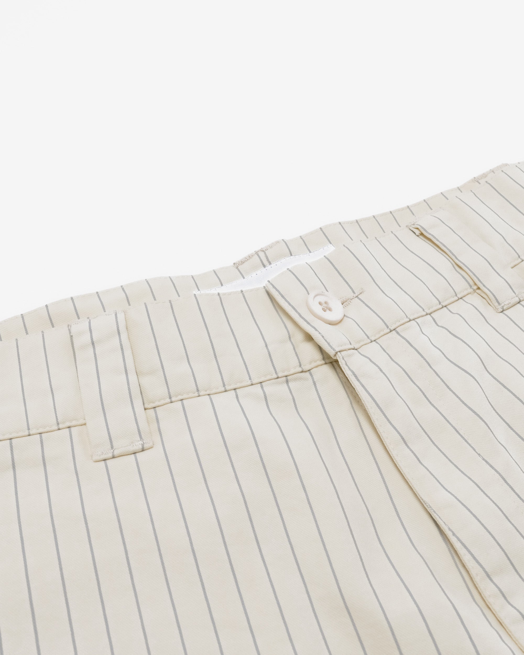 Close-up of a beige striped shirt with a button on a white background