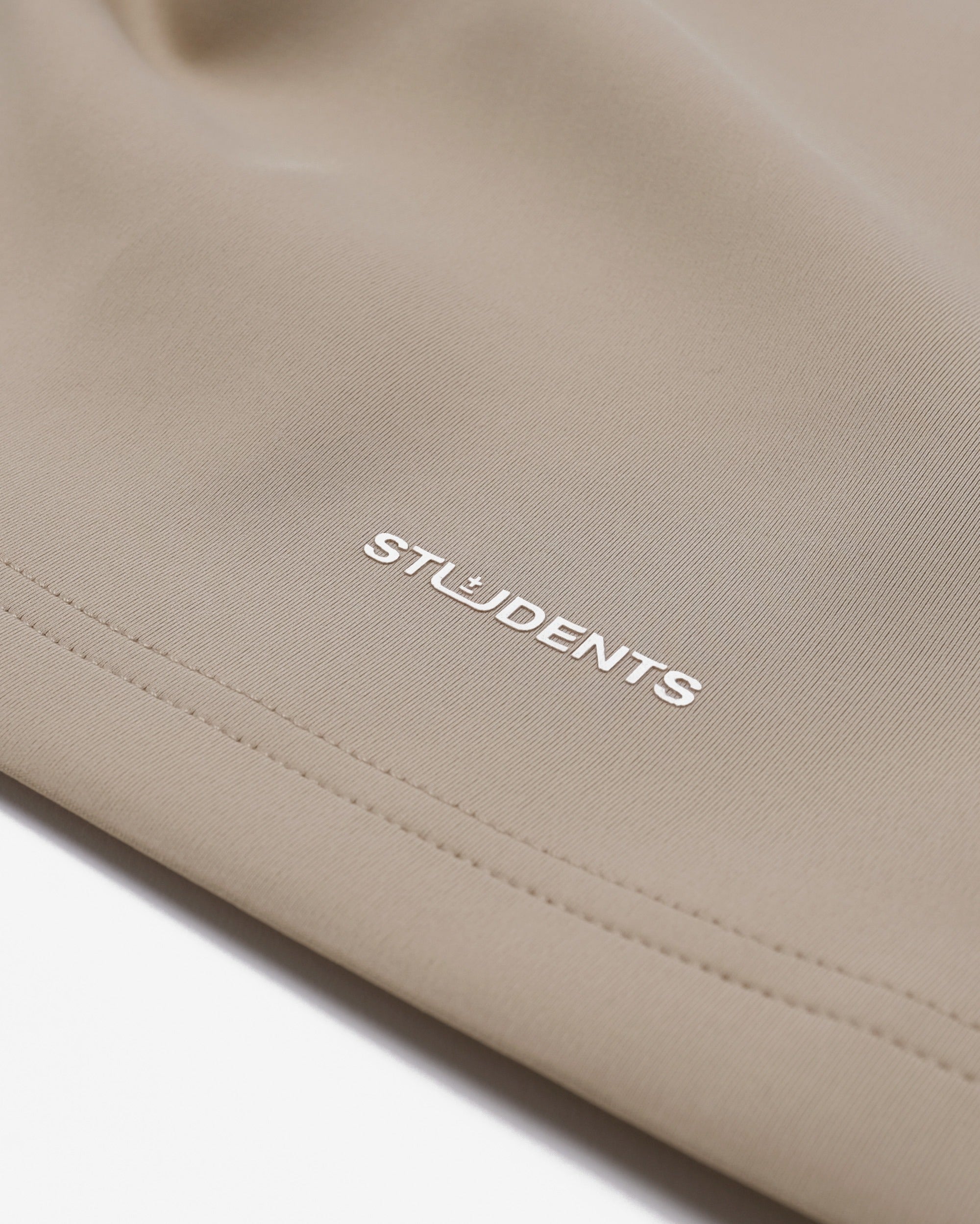 Beige fabric with 'STUDENTS' embroidered on it