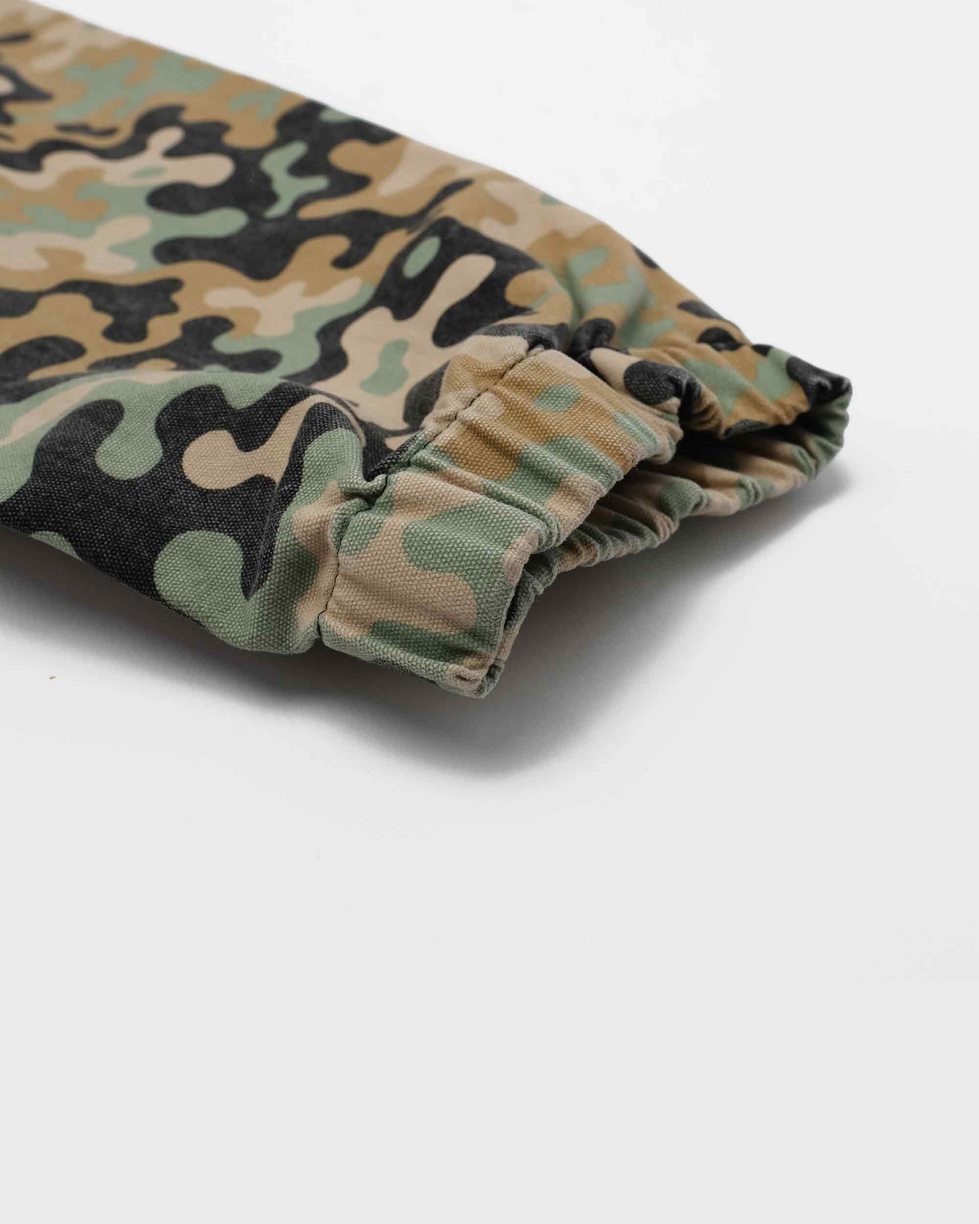 Rolled-up camouflage fabric on a white background