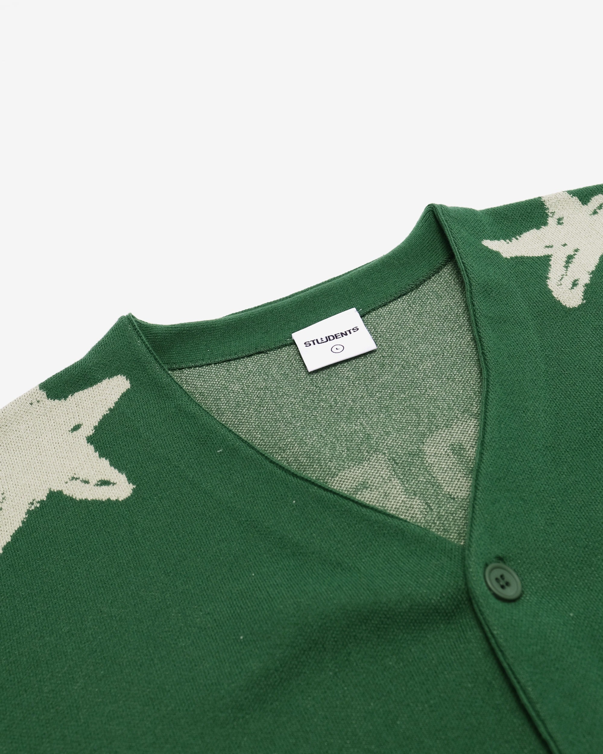Green garment with star pattern and brand label on a white background