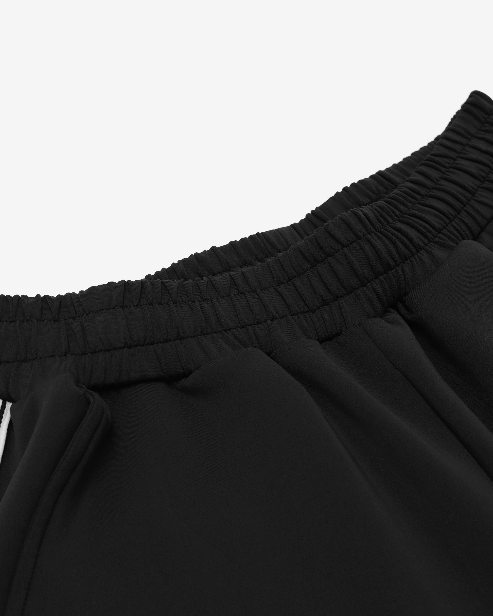 Close-up of black pants with a white background